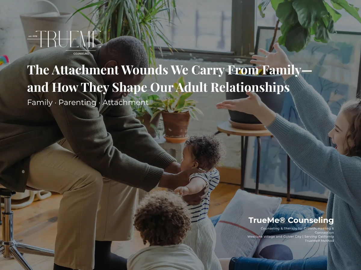 Family scene in a counseling setting: a man leans toward a baby while a woman raises her arms in encouragement, with TrueMe Counseling branding visible.
